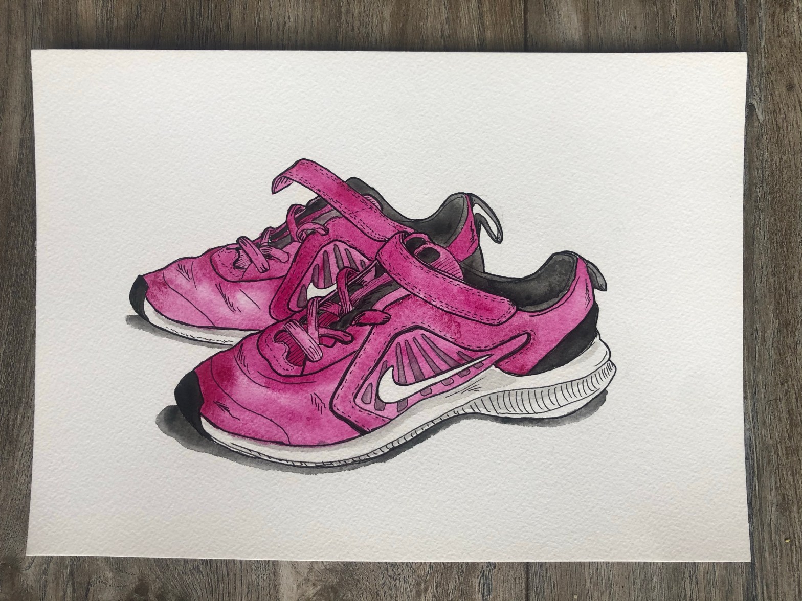 Watercolor illustration of kids Nike shoes.